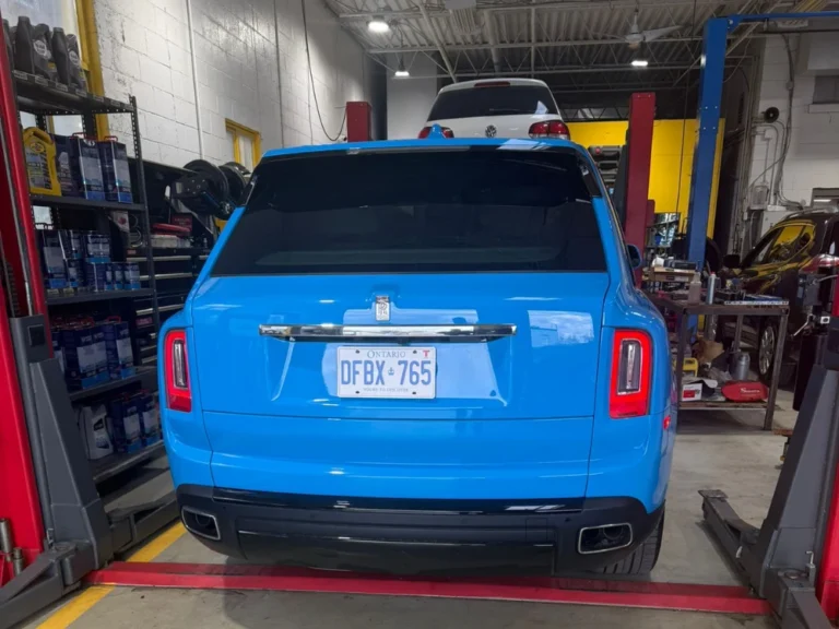 Blue Rolls-Royce Cullinan inside the 404 Auto Repair shop